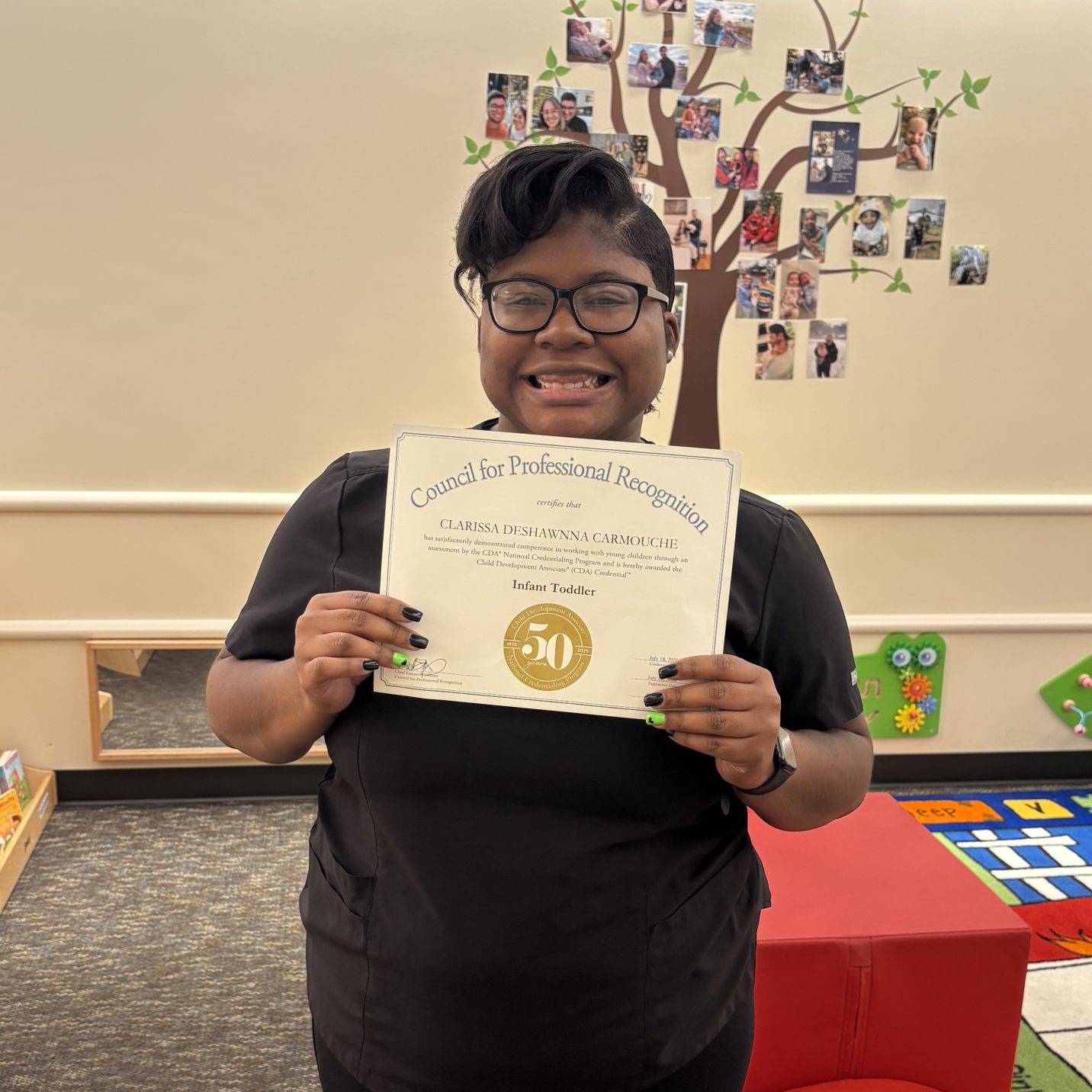 Clarissa holds CDA certificate in ELC classroom.