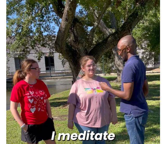 Young man intervieiwing college students.