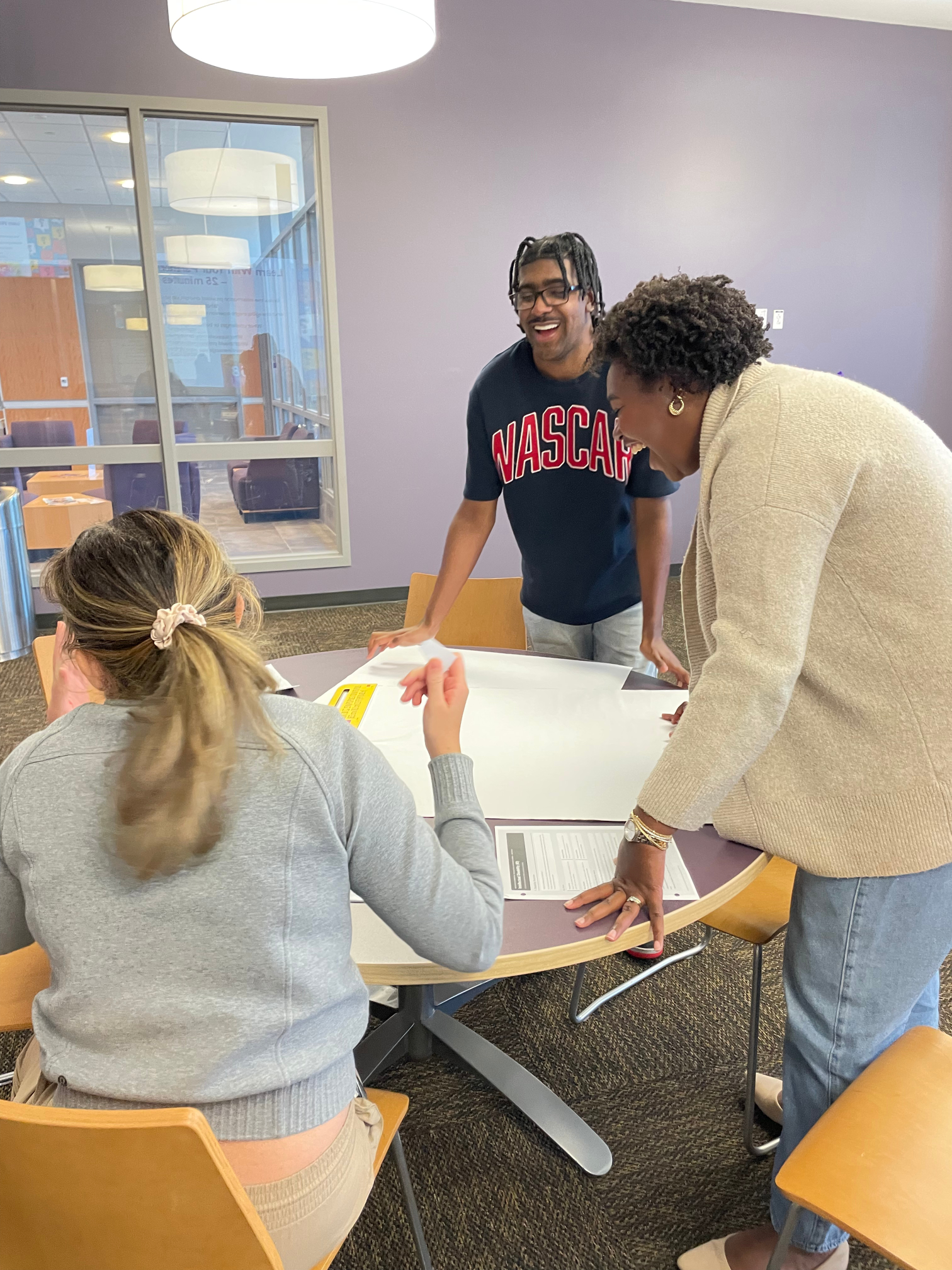 A self-advocate, a social work student, and audiology student work together.