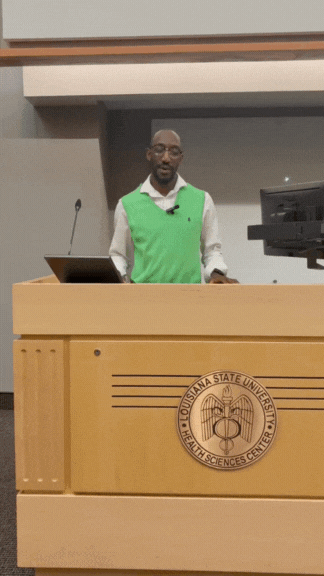 Will Johnson speaking at a podium wiht the LSUHSC seal.