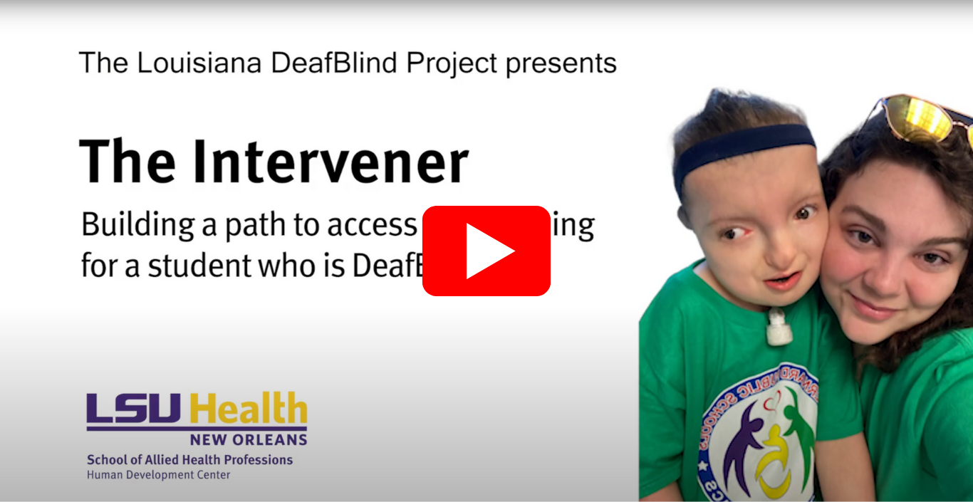 Screenshot of a video featuring a Girl with a trach and hearing aid smiles with her para. Teh video also features a red play symbol above text that reads "The Louisiana DeafBlind Project presents The Intervener, Building a path to access and learning for a student who is DeafBlind"