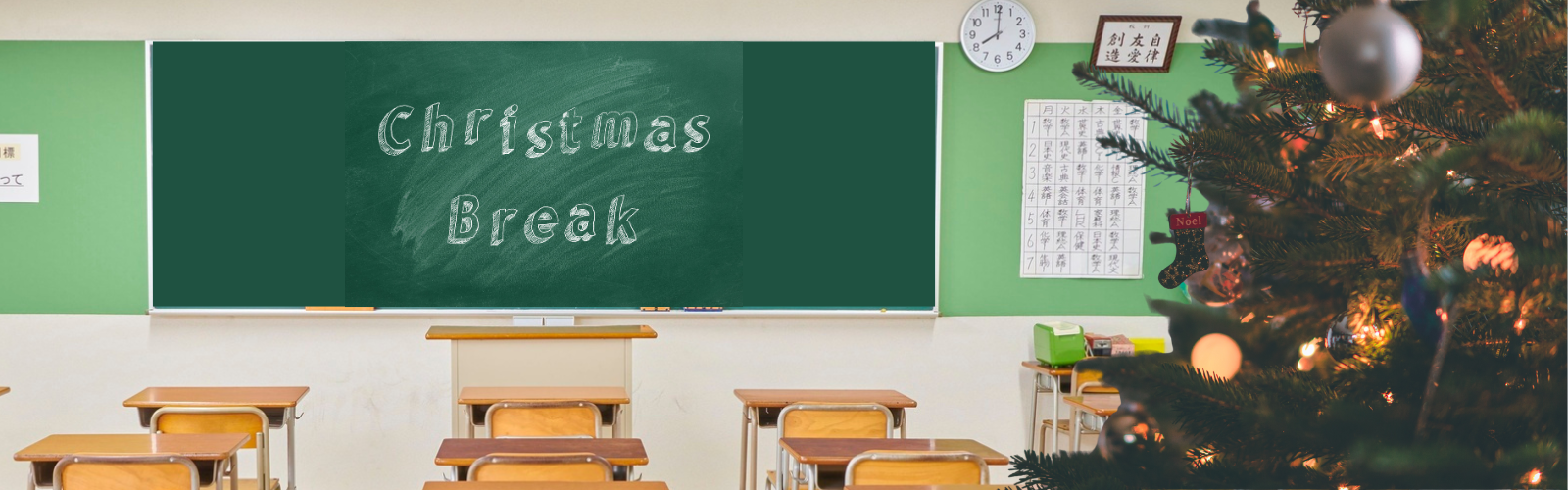 Empty classroom with "Chrismas Break" written on chalkboard and decorated christams tree on right side of classroom.