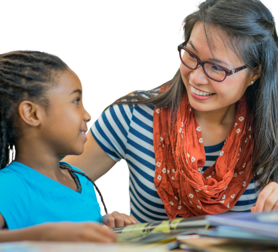 Teacher helps student with school work.