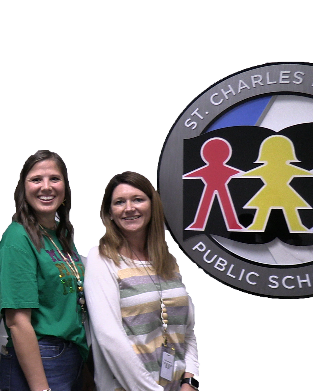 Teachers stand smiling next to St Charles Public Schools logo.