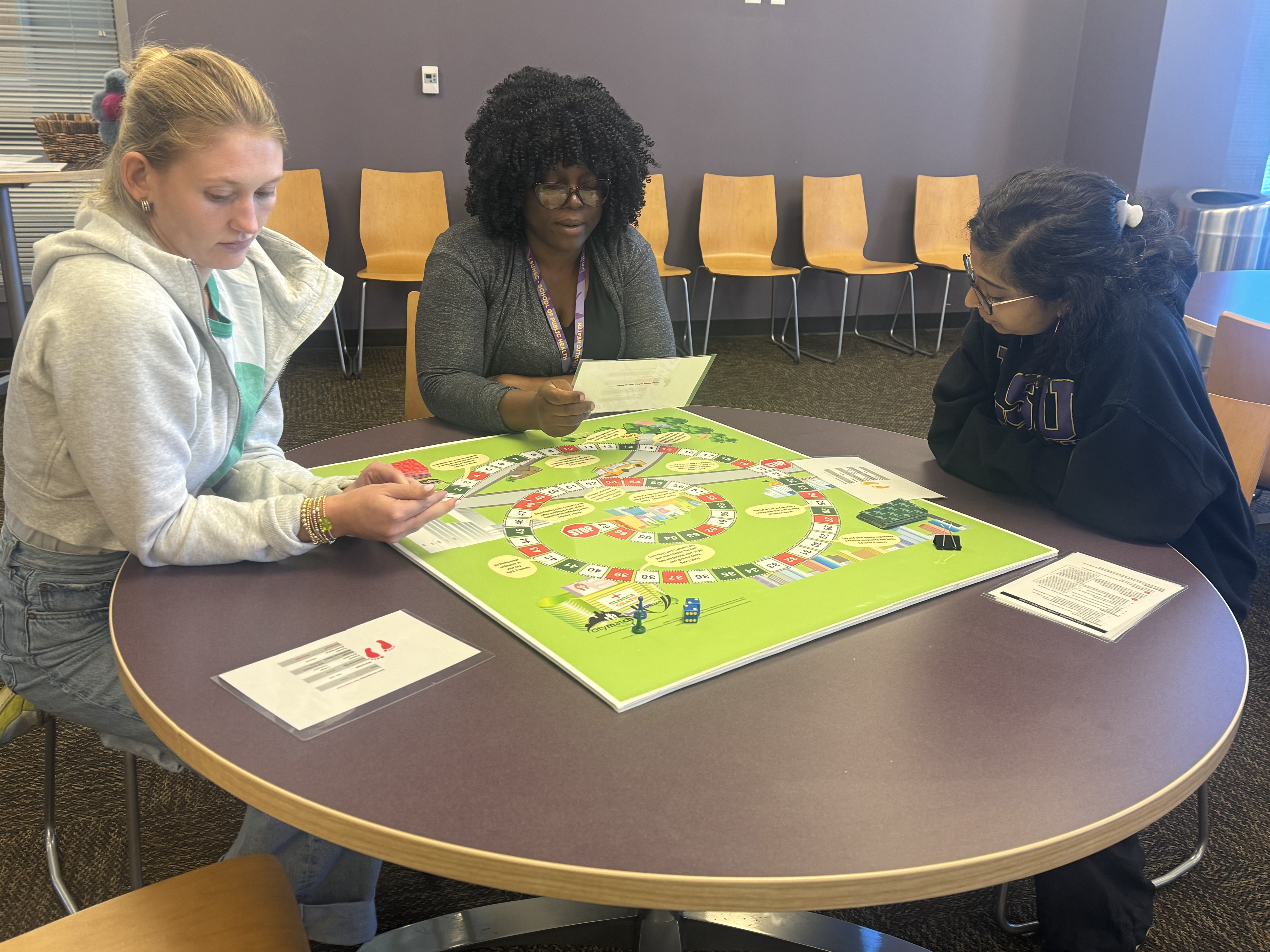 LEND scholar play a board game about the Life Course.