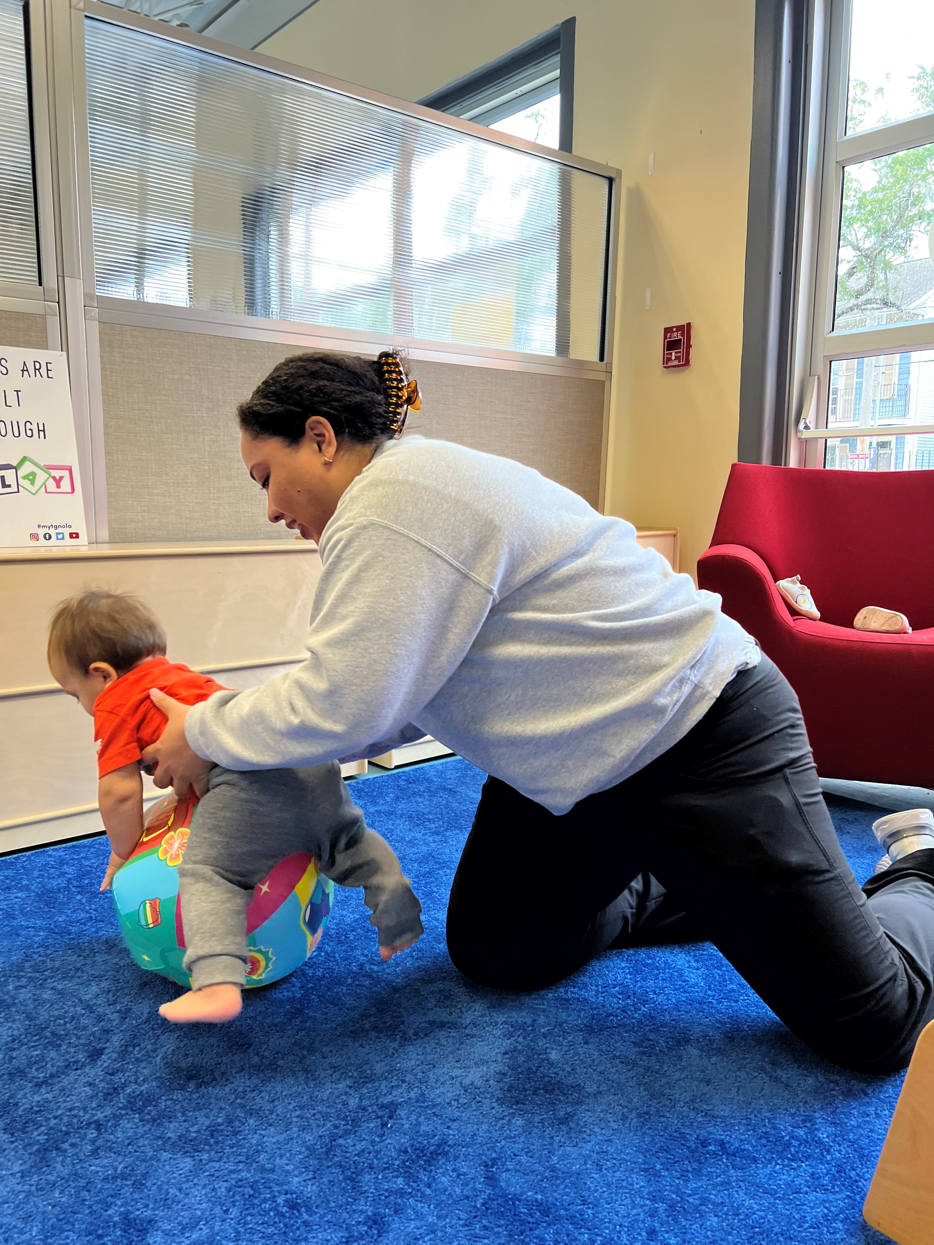 LEND scholar holds baby during screening evaluation.