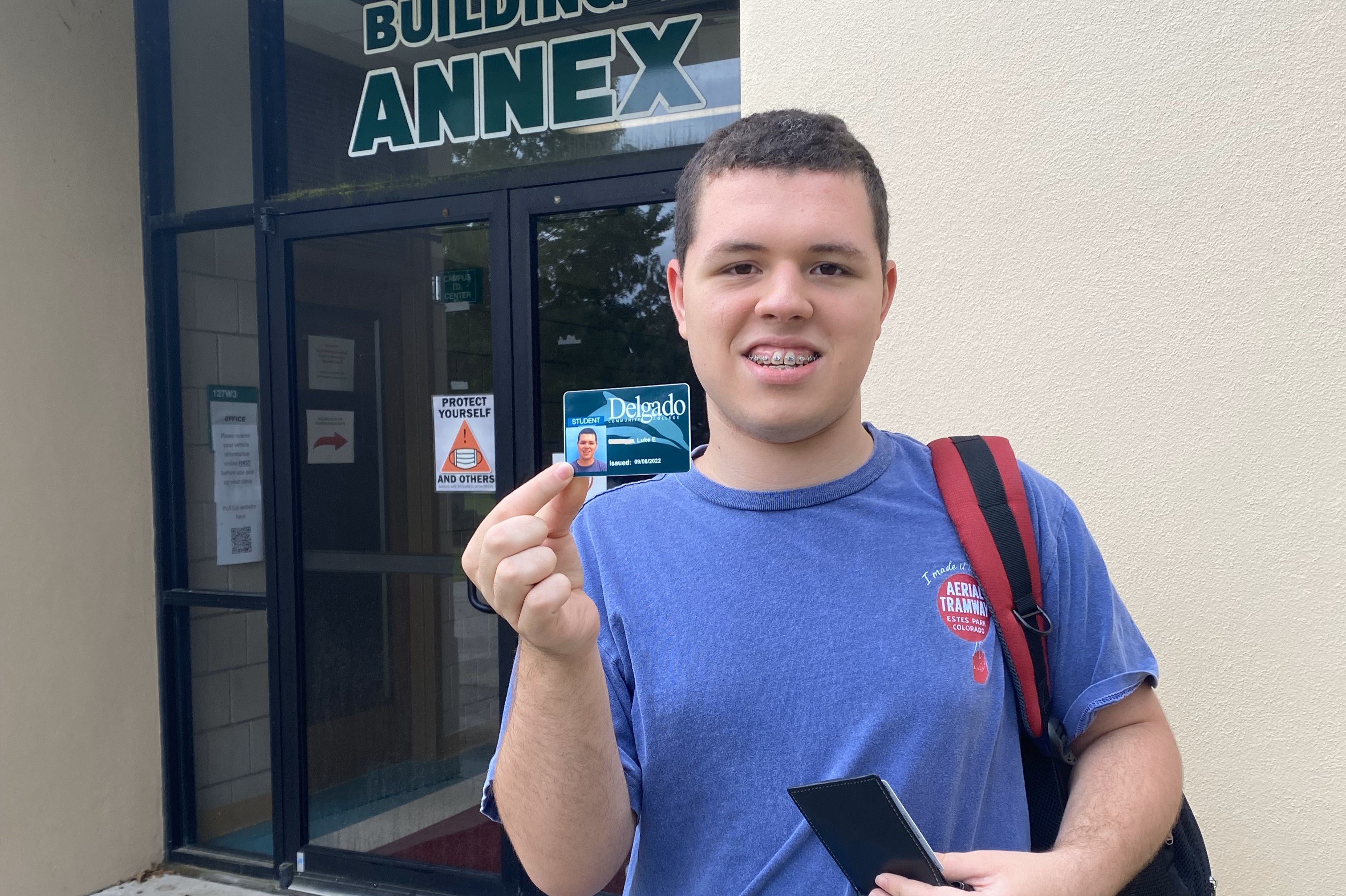 PAYCheck student shows his Delgado student ID.