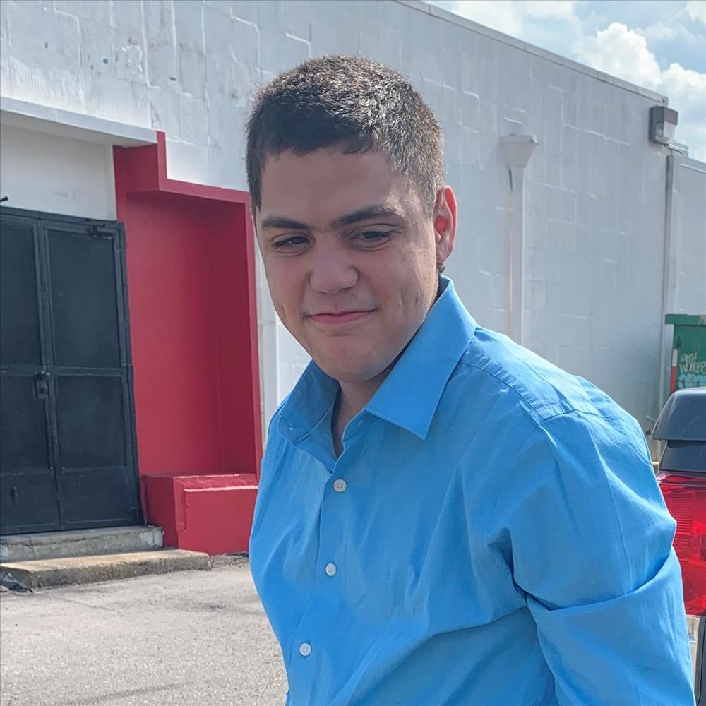 Scott Rose smiling wearing blue dress shirt.